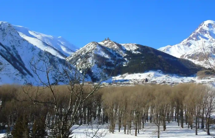 Snowy peak of Mount Kazbek behind Gergeti Trinity Church
