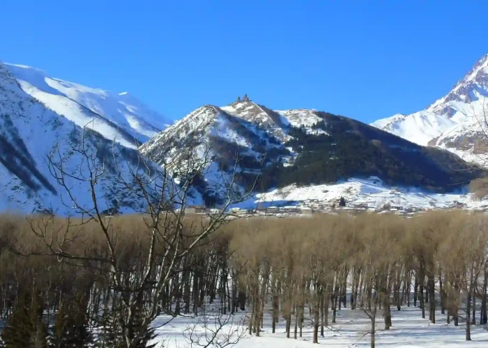 Snowy peak of Mount Kazbek behind Gergeti Trinity Church
