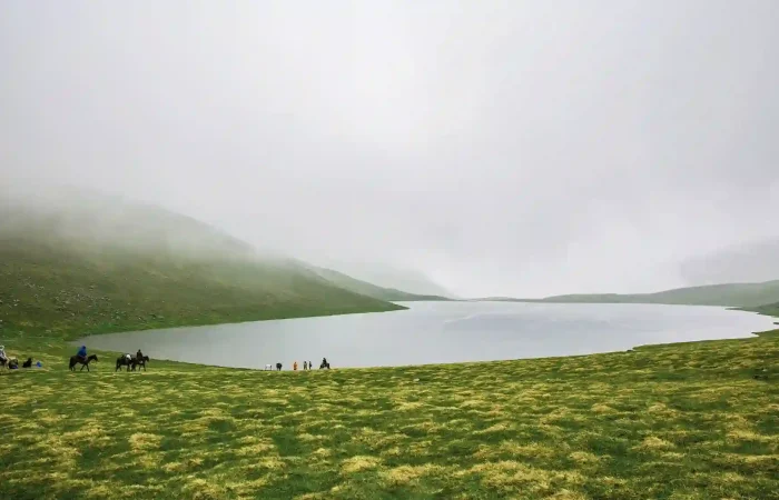 Mist covered mountain lake in the Greater Caucasus