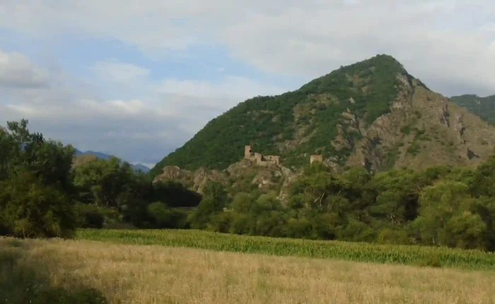 The ancient stone ruins of Slesa Fortress overlooking the river in the Meskheti region