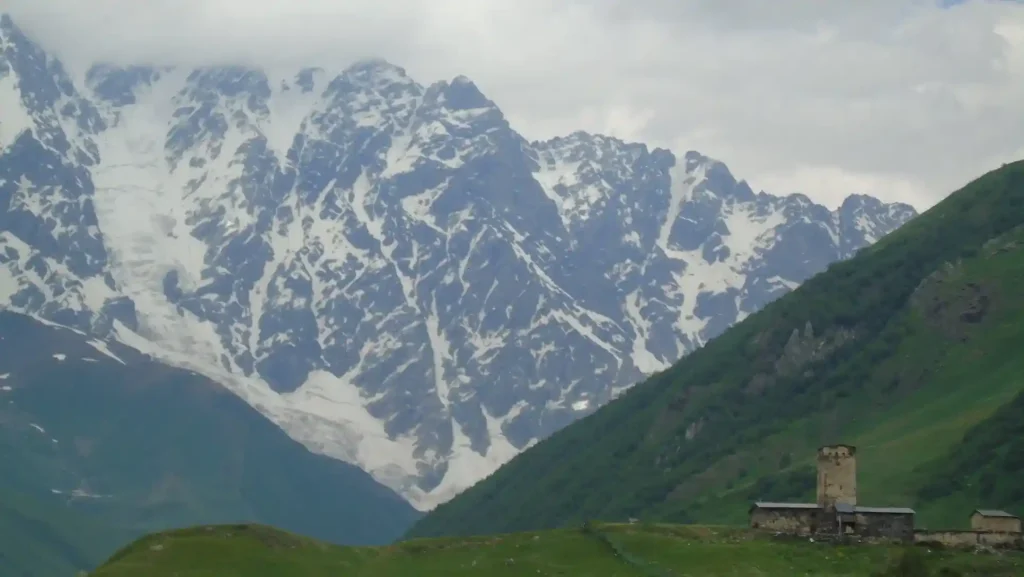 Ancient tower and the Lamaria Church in Ushguli, a religious landmark on a cultural tour in Georgia