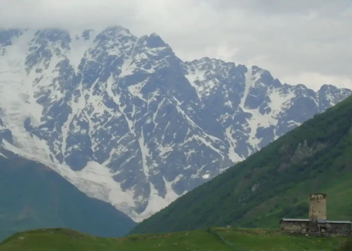 Ancient tower and the Lamaria Church in Ushguli, a religious landmark on a cultural tour in Georgia