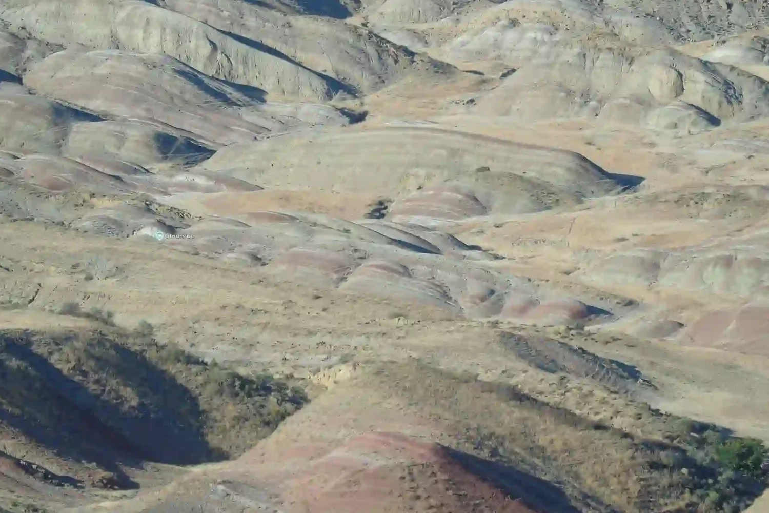 Horizontal colored soil layers and rocks in Gareja desert