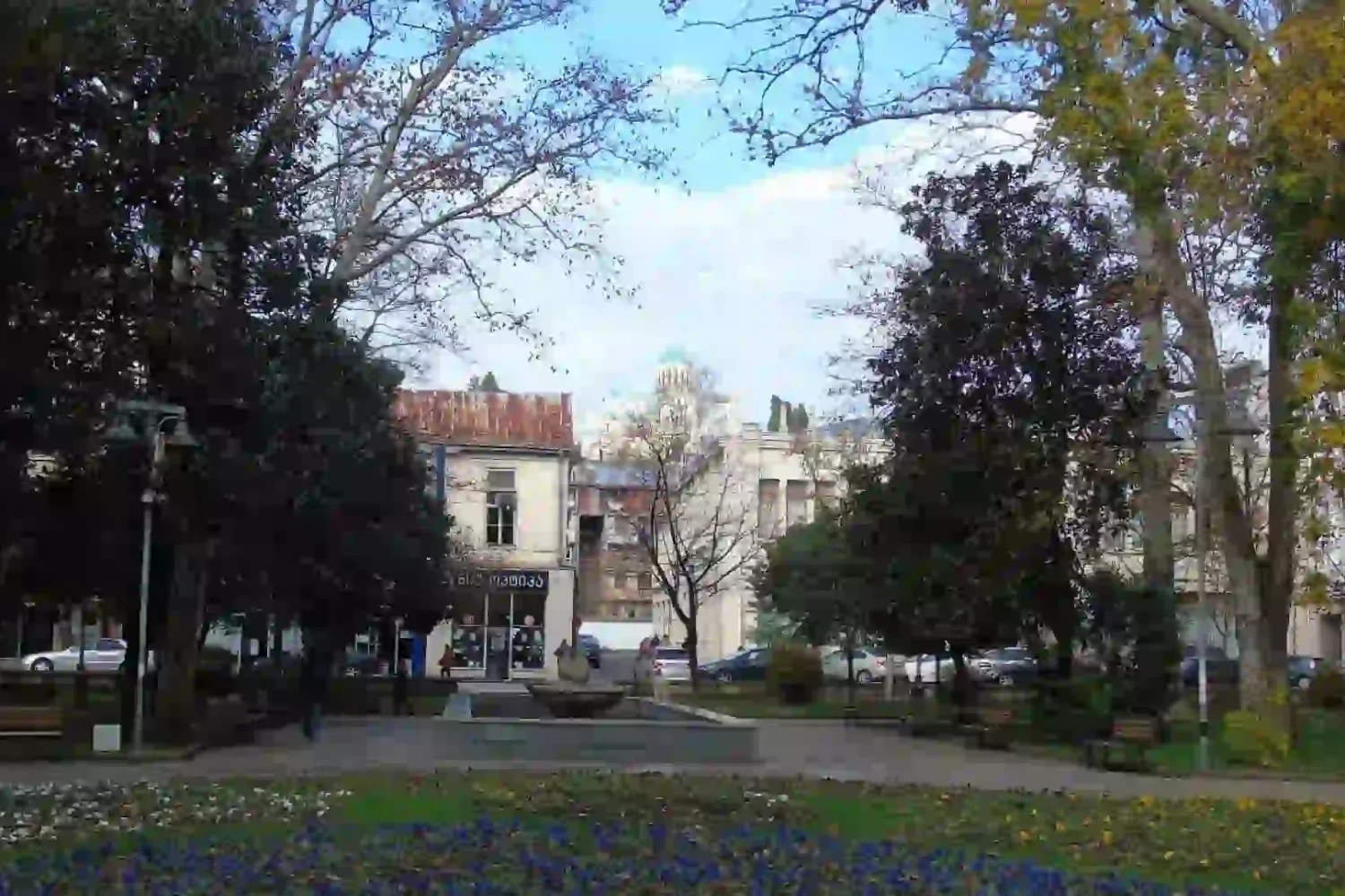 View of Bagrati Cathedral through the blooming flowers of Kutaisi garden.