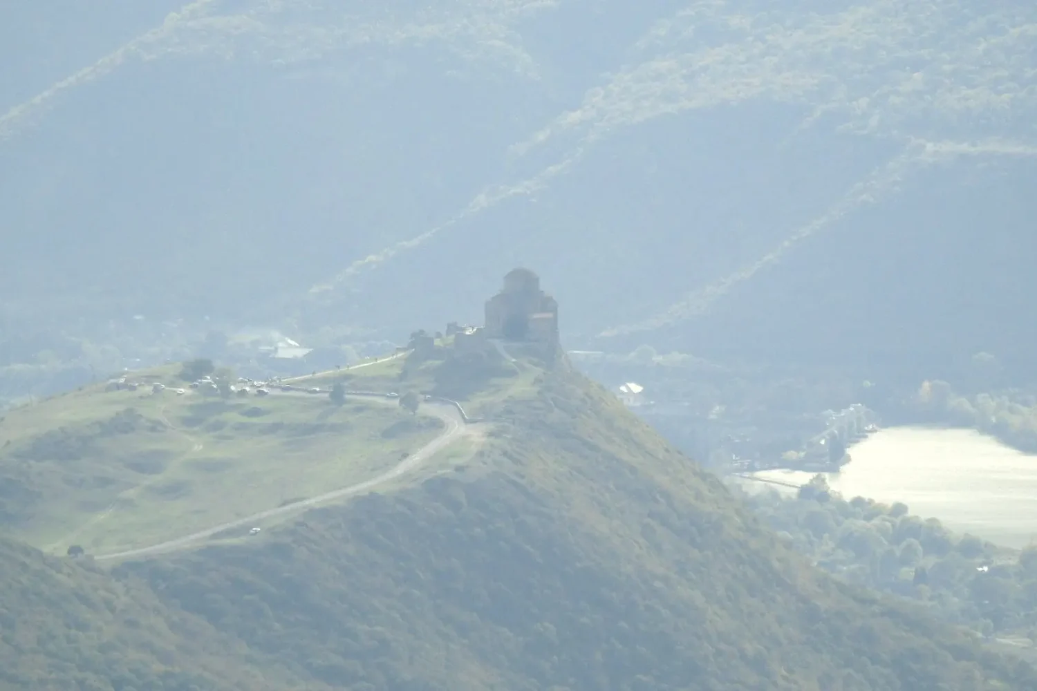 Aerial view of Jvari Monastery against diagonal mountain ranges