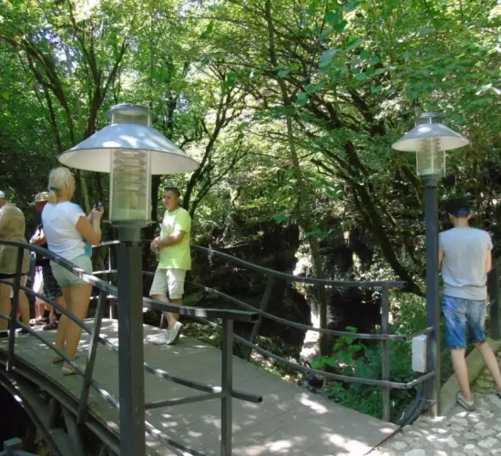 Tourists on a small bridge exploring the natural beauty of Martvili area