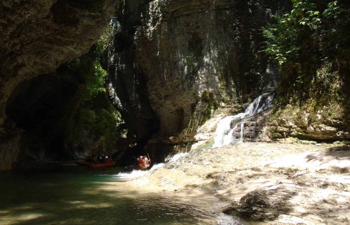 Martvili Canyon, small waterfall, tourists in boats