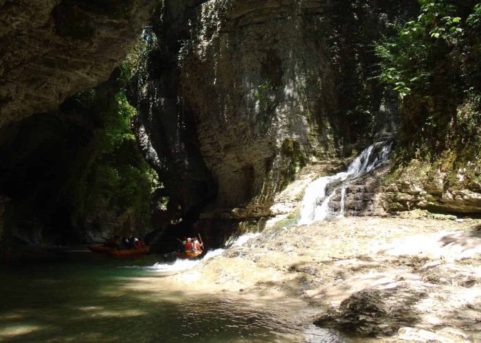 Martvili Canyon, small waterfall, tourists in boats