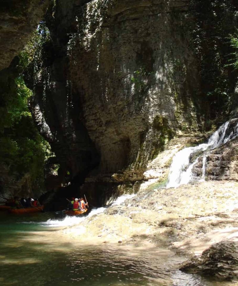 Martvili Canyon, small waterfall, tourists in boats