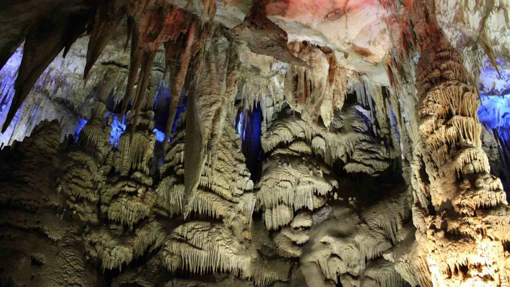 The interior of the Sataplia cave with colorful lights