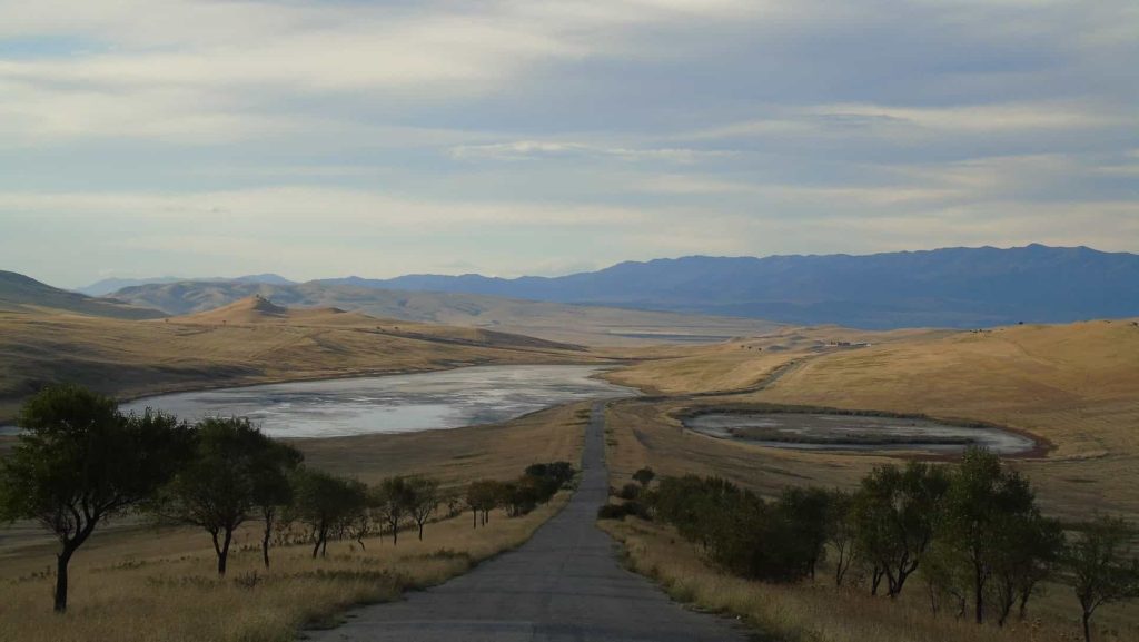 In the foreground, the road from David Gareja to Tbilisi, salt lakes on the left and right