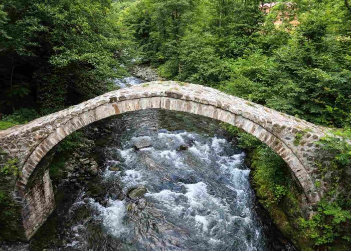 A medieval stone King Tamar bridge over a small river