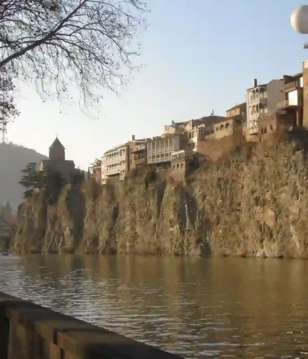 The colorful wooden balconies and historic brick domes of the sulfur baths in Old Town during a cultural visit to Tbilisi, Georgia.