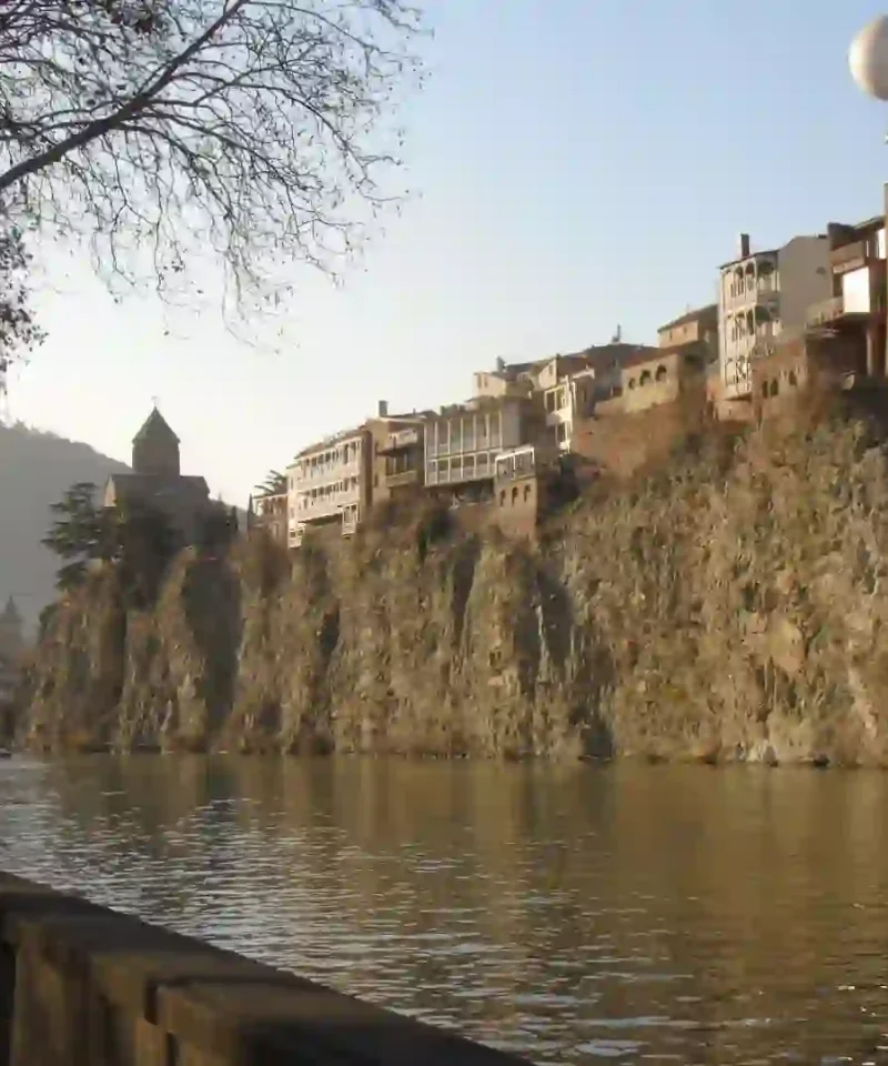 The colorful wooden balconies and historic brick domes of the sulfur baths in Old Town during a cultural visit to Tbilisi, Georgia.